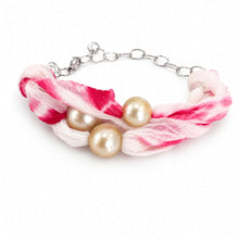 Load image into Gallery viewer, A bracelet featuring three large cream-colored pearls on a twisted, sheer pink and white fabric wrap with a silver-tone chain extender.
