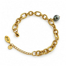 Load image into Gallery viewer, A gold chain bracelet with textured links, an extender chain, a small oval tag engraved with 'FIJI', , and a dark grey/black pearl, displayed on a clean white background.