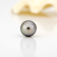 Load image into Gallery viewer, Single pearl on a reflective surface with a blurred background