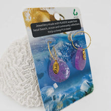 Load image into Gallery viewer, Jewellery made from plastic waste on Fiji packaging with purple and gold earrings.