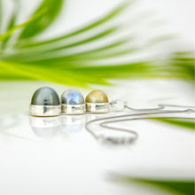Load image into Gallery viewer, Silver necklace with three gemstones against a blurred natural background