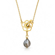 Load image into Gallery viewer, A gold necklace featuring a flower-shaped pendant with a dangling baroque pearl, shown against a plain white background.