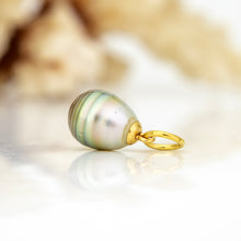 Load image into Gallery viewer, A teardrop-shaped freshwater pearl pendant with iridescent green, blue, and gold tones, attached to a polished yellow gold loop, displayed on a reflective white surface.