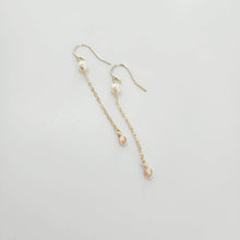 Load image into Gallery viewer, A pair of freshwater pearl drop earrings with glass bead detail, hanging from 14k gold fill metal hooks, displayed against a white background.