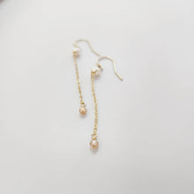 Load image into Gallery viewer, A pair of freshwater pearl drop earrings with glass bead detail, hanging from 14k gold fill metal hooks, displayed against a white background.