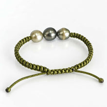 Load image into Gallery viewer, An olive green adjustable macrame bracelet featuring three freshwater pearls in gray, cream, and olive tones, displayed on a clean white background.
