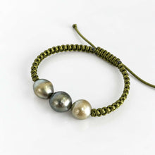 Load image into Gallery viewer, An olive green macrame bracelet featuring three baroque pearls in shades of gray, silver, and champagne, displayed on a clean white background.

