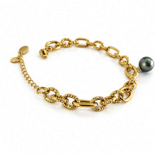 Load image into Gallery viewer, A gold chain bracelet with textured links, a small charm, and a dark gray pearl, displayed on a clean white background.
