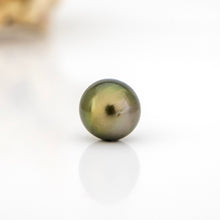 Load image into Gallery viewer, Single pearl on a reflective surface with a blurred background
