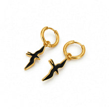 Load image into Gallery viewer, A pair of gold hoop earrings with black and gold bird charms, displayed on a clean white background.
