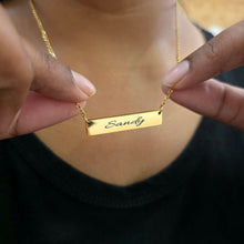 Load image into Gallery viewer, Gold necklace with 'Sandy' engraved on a blurred background
