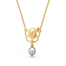 Load image into Gallery viewer, A gold chain necklace featuring a cutout flower pendant and a dangling gry pearl, shown on a plain white background.
