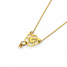 Load image into Gallery viewer, A gold-toned necklace featuring a cutout floral pendant with pearl setting, shown against a plain white background.
