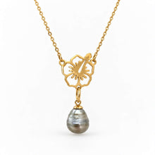 Load image into Gallery viewer, A gold chain necklace featuring a flower-shaped pendant with a dangling teardrop-shaped gray pearl, set against a plain white background.
