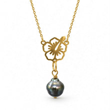 Load image into Gallery viewer, A gold necklace featuring a cutout flower pendant with a dangling baroque pearl, shown against a plain white background.
