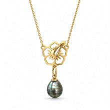 Load image into Gallery viewer, A gold necklace featuring a flower-shaped pendant with a dangling dark green iridescent pearl, shown against a plain white background.
