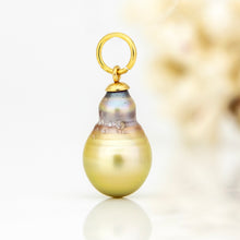 Load image into Gallery viewer, A gold pendant charm featuring a large, teardrop-shaped pearl with a pearlescent gold body and subtle iridescent purple-blue undertones near the top, suspended from a polished gold ring.
