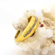 Load image into Gallery viewer, Gold ring with embedded stones on a coral
