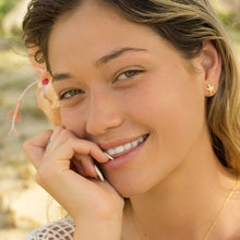 Load image into Gallery viewer, Mini starfish earrings and necklace worn by a model with bright background
